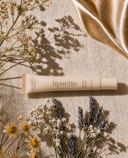 : Lipsette overnight lip mask tube on beige surface with flower